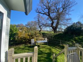 A garden area with a table and chairs at Kelling Heath Holiday Park - Holiday Accommodation 16498, Holt