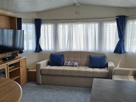 A living room with a sofa and television at Hayling Island Holiday Park - Meadow Bay Villages - Holiday Accommodation 16626 in Hayling Island