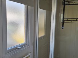A bathroom with a shower and window at Hayling Island Holiday Park - Meadow Bay Villages - Holiday Accommodation 16626, Hayling Island