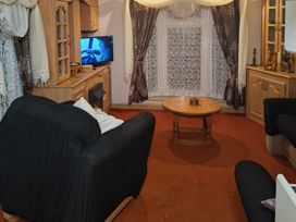 A living room with a coffee table and television at The Chase - Holiday Accommodation 1675 Ingoldmells