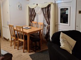 A dining room with a table and chairs at The Chase - Holiday Accommodation 1675 Ingoldmells