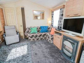 A living room with a sofa and armchair at WigBay Holiday Park - Holiday Accommodation 16774 in Stranraer
