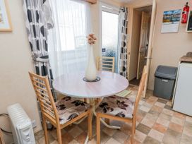 A dining room with a table and chairs at WigBay Holiday Park - Holiday Accommodation 16774 Stranraer