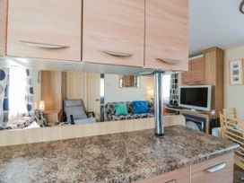 A living room with a sofa and television at WigBay Holiday Park - Holiday Accommodation 16774 Stranraer