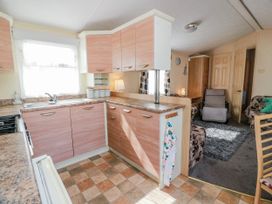 A kitchen with cabinets and a stove at WigBay Holiday Park - Holiday Accommodation 16774, Stranraer