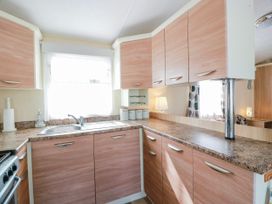 A kitchen with a sink and cupboards at WigBay Holiday Park - Holiday Accommodation 16774 Stranraer