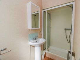 A bathroom with a sink and shower at WigBay Holiday Park - Holiday Accommodation 16774, Stranraer