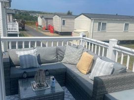 a patio seating area with gray cushions and a coffee table at Quay West Holiday Park - Holiday Accommodation 16905 New Quay