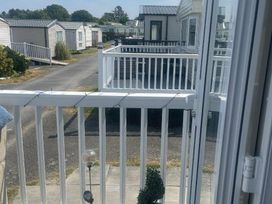 a view from a balcony overlooking a path with holiday homes at Quay West Holiday Park - Holiday Accommodation 16905 in New Quay