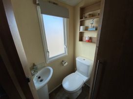 A bathroom with a toilet and sink at Chesil Beach Holiday Park - Holiday Accommodation 16933, Weymouth