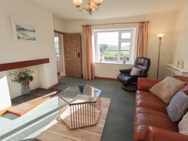 A living room with a sofa and coffee table at 2 Lupton Hall Cottages in Carnforth