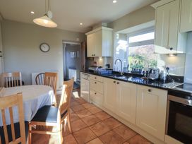 A kitchen with a table and chairs at 2 Lupton Hall Cottages Carnforth