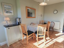 A dining room with a table and chairs at 2 Lupton Hall Cottages in Carnforth