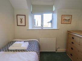 A bedroom with a bed and artwork at 2 Lupton Hall Cottages in Carnforth
