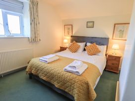 A bedroom with a bed and bedside tables at 2 Lupton Hall Cottages in Carnforth