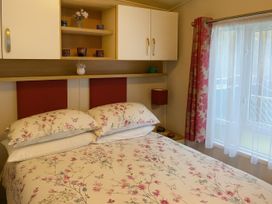 A bedroom with a bed and shelf at Freshwater Beach Holiday Park - Holiday Accommodation 17116 near Burton Bradstock