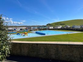 An outdoor swimming pool with water slides at Freshwater Beach Holiday Park - Holiday Accommodation 17116 near Burton Bradstock