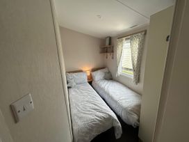 A bedroom with two single beds and a window at Trecco Bay - Holiday Accommodation 17447 Porthcawl