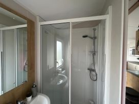 A bathroom with shower and sink at Trecco Bay - Holiday Accommodation 17447 Porthcawl