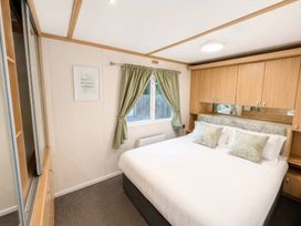 A bedroom with a bed and cabinets at Marsh Farm Holiday Park - Holiday Accommodation 17738 in Great Yarmouth