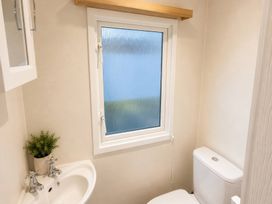 A bathroom with a sink and toilet at Marsh Farm Holiday Park - Holiday Accommodation 17738, Great Yarmouth