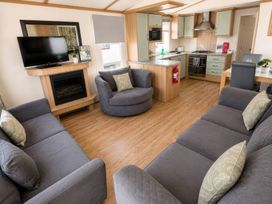 A living room with a television and couch at Marsh Farm Holiday Park - Holiday Accommodation 17738, Great Yarmouth