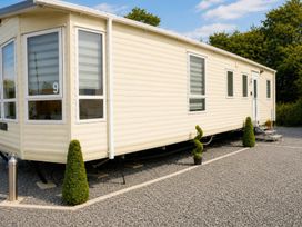 A mobile home with windows and steps at Marsh Farm Holiday Park - Holiday Accommodation 17738, Great Yarmouth