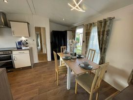 a dining area with a table set for four at Golden Palm Resort - Holiday Accommodation 17870 in Chapel St Leonard's