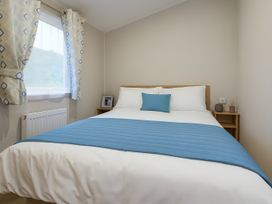 A bedroom with a bed and window at Marton Mere Holiday Village - Holiday Accommodation 17890 in Blackpool
