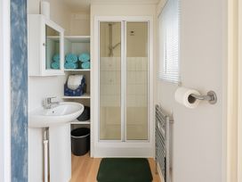 A bathroom with a shower and sink at Promenade Site - Holiday Accommodation 18142 Skegness