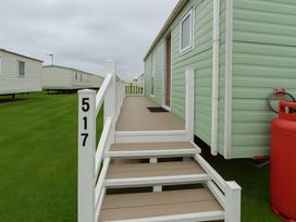 A mobile home with steps leading to the entrance at Promenade Site - Holiday Accommodation 18142 Skegness