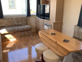 A living room with a sofa and a television at Whitehouse Leisure Park - Holiday Accommodation 18340, Towyn
