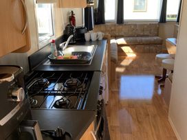 A kitchen with a sink and stove at Whitehouse Leisure Park - Holiday Accommodation 18340 Towyn