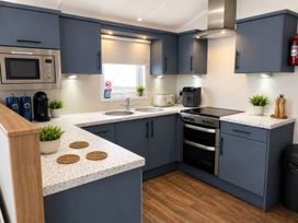 A kitchen with appliances and countertops at Trecco Bay - Holiday Accommodation 18462 Porthcawl
