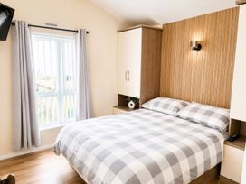 A bedroom with a bed and window at Trecco Bay - Holiday Accommodation 18462, Porthcawl
