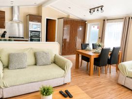 A living room with a dining area at Trecco Bay - Holiday Accommodation 18463, Porthcawl