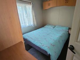 a bedroom with a double bed and a window at Promenade Site - Holiday Accommodation 18601 in Ingoldmells