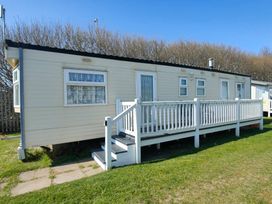 a holiday home with a deck and steps at Promenade Site - Holiday Accommodation 18601 in Ingoldmells
