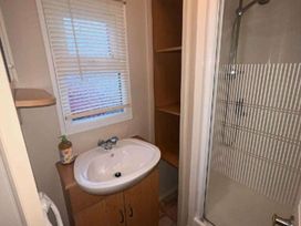 a small bathroom with a sink and shower at Promenade Site - Holiday Accommodation 18601 in Ingoldmells