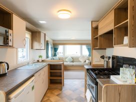 A kitchen with sink and cooker at Marton Mere Holiday Village - Holiday Accommodation 18682, Blackpool