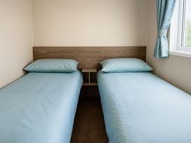 A bedroom with two single beds at Marton Mere Holiday Village - Holiday Accommodation 18682, Blackpool