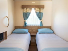 A bedroom with two beds and a window at Marton Mere Holiday Village - Holiday Accommodation 18682, Blackpool