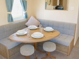 A dining room with a table and chairs at Marton Mere Holiday Village - Holiday Accommodation 18682, Blackpool