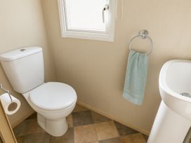 A bathroom with a toilet and a sink at Marton Mere Holiday Village - Holiday Accommodation 18682, Blackpool