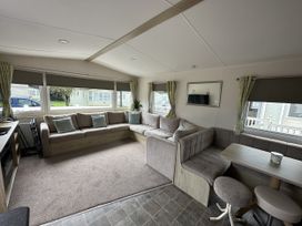 A living room with a sofa and a table at Shorefield Country Park - Holiday Accommodation 18837 in Lymington
