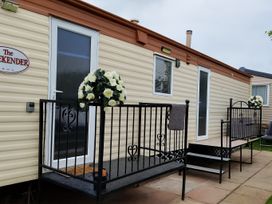 A caravan exterior with steps and flower arrangement at Millers Cottage Caravan Park - Holiday Accommodation 18845, Towyn, Abergele