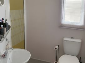 A bathroom with a sink and toilet at Millers Cottage Caravan Park - Holiday Accommodation 18845, Towyn, Abergele