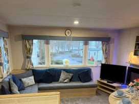 A living room with a sofa and television at Marton Mere Holiday Village - Holiday Accommodation 18865, Blackpool