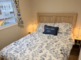 A bedroom with a bed and window at Marton Mere Holiday Village - Holiday Accommodation 18865, Blackpool