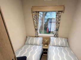 A bedroom with two beds and a window at Marton Mere Holiday Village - Holiday Accommodation 18865, Blackpool